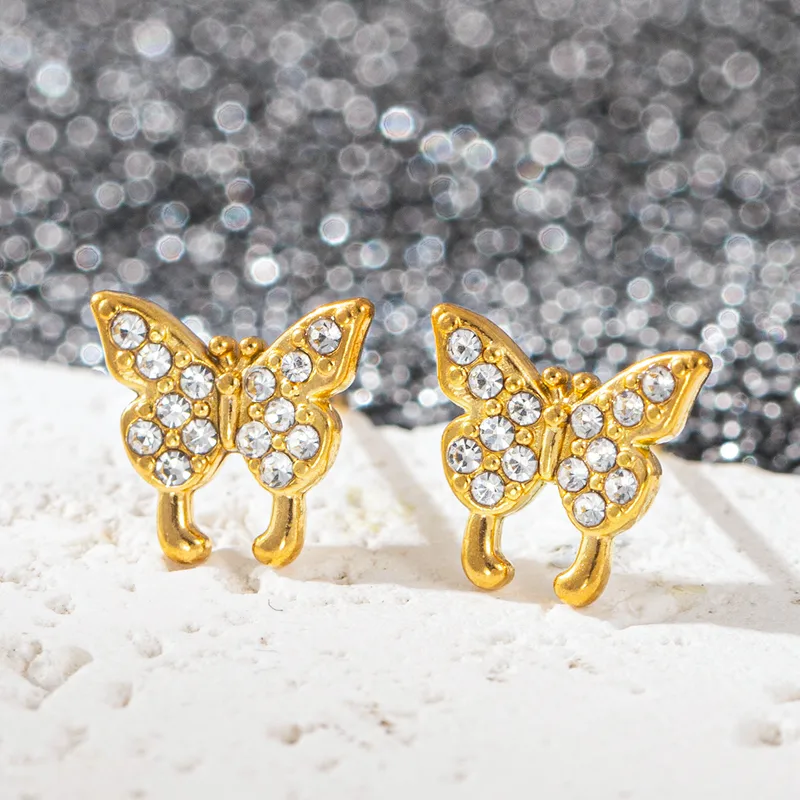 Hochwertige Edelstahl Ohrstecker in Gold-Zirkonia (Schmetterling). Wasserfest und langlebig.