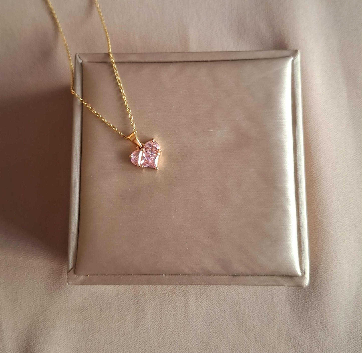 Hochwertige Edelstahl-Kette mit edlen goldenen Herz-Anhänger und funkelnden, rosa Zirkonia. Langlebig, wasserfest, hypoallergen und alltagstauglich